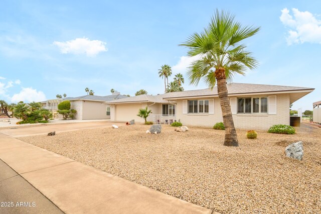 15430 N Bowling Green Dr, Sun City, AZ 85351 - ranch-style home with concrete driveway, a garage, and brick siding