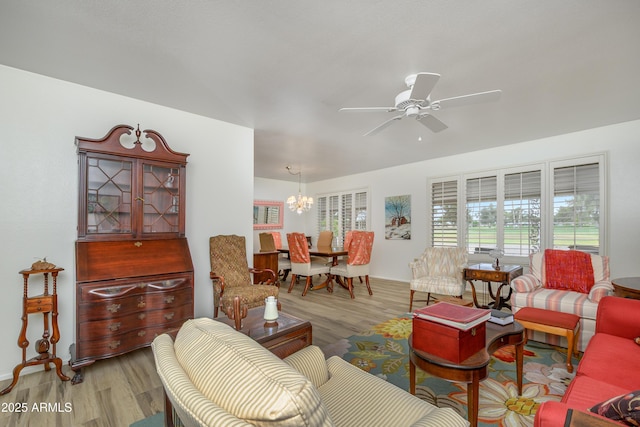 15430 N Bowling Green Dr, Sun City, AZ 85351 - living area featuring baseboards, wood finished floors, and ceiling fan with notable chandelier
