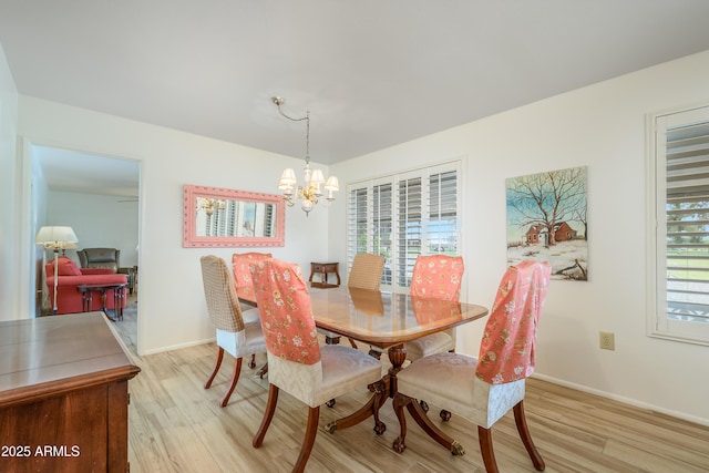 15430 N Bowling Green Dr, Sun City, AZ 85351 - dining space with baseboards, a notable chandelier, and light wood-style floors