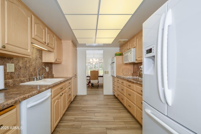 15430 N Bowling Green Dr, Sun City, AZ 85351 - kitchen with a sink, white appliances, a chandelier, decorative backsplash, and light brown cabinetry
