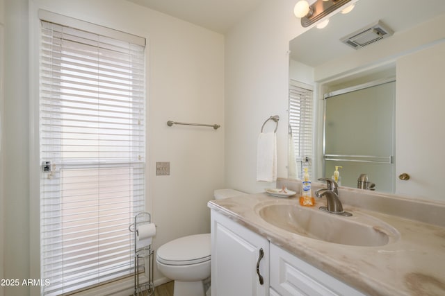 15430 N Bowling Green Dr, Sun City, AZ 85351 - full bath featuring vanity, toilet, plenty of natural light, and visible vents