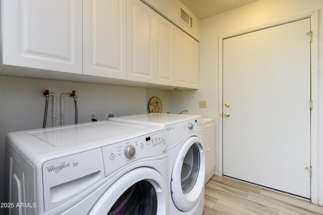 15430 N Bowling Green Dr, Sun City, AZ 85351 - washroom featuring cabinet space, independent washer and dryer, visible vents, and light wood-style flooring