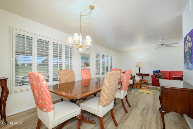 15430 N Bowling Green Dr, Sun City, AZ 85351 - dining room with baseboards, light wood-style flooring, and ceiling fan with notable chandelier