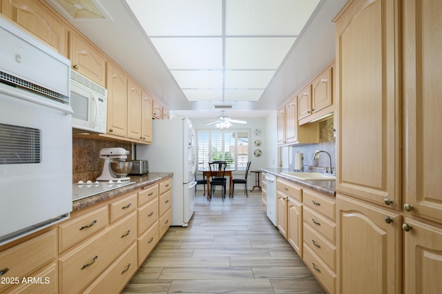 15430 N Bowling Green Dr, Sun City, AZ 85351 - kitchen with a sink, decorative backsplash, light brown cabinets, and white appliances