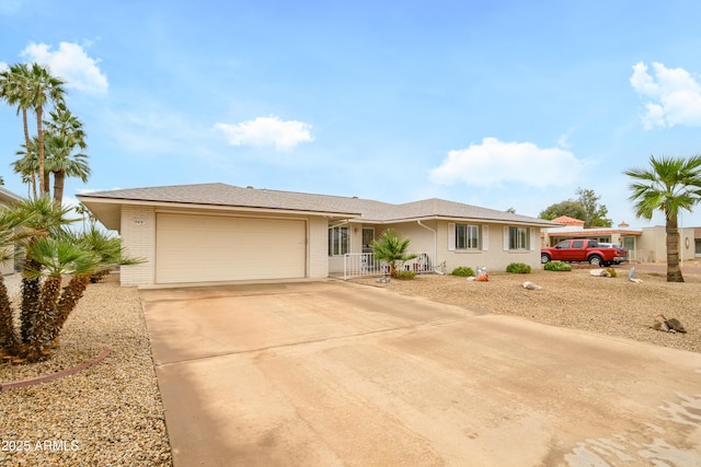 15430 N Bowling Green Dr, Sun City, AZ 85351 - view of front of home with concrete driveway, brick siding, and a garage