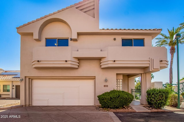 6510 S Hazelton Ln Unit 101, Tempe, AZ 85283 - view of front of home with a garage, stucco siding, driveway, and a tile roof
