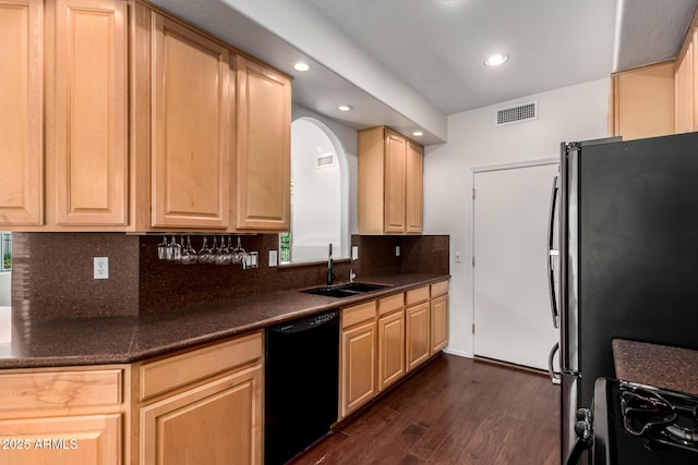6510 S Hazelton Ln Unit 101, Tempe, AZ 85283 - kitchen featuring black appliances, dark wood finished floors, dark countertops, light brown cabinets, and recessed lighting