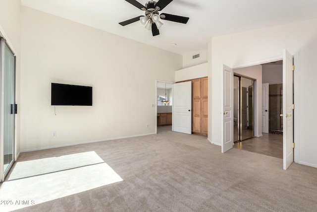 6510 S Hazelton Ln Unit 101, Tempe, AZ 85283 - unfurnished bedroom featuring light colored carpet, vaulted ceiling, connected bathroom, and ceiling fan