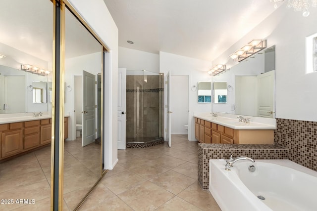 6510 S Hazelton Ln Unit 101, Tempe, AZ 85283 - bathroom with a stall shower, vanity, a garden tub, and tile patterned floors