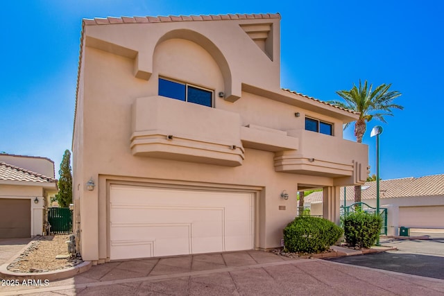 6510 S Hazelton Ln Unit 101, Tempe, AZ 85283 - view of front of property with an attached garage, stucco siding, and a balcony