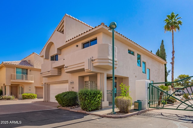 6510 S Hazelton Ln Unit 101, Tempe, AZ 85283 - view of front of home with stucco siding, a tile roof, a garage, and a gate