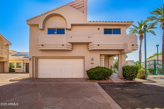 6510 S Hazelton Ln Unit 101, Tempe, AZ 85283 - view of front facade featuring stucco siding, an attached garage, concrete driveway, and a tiled roof