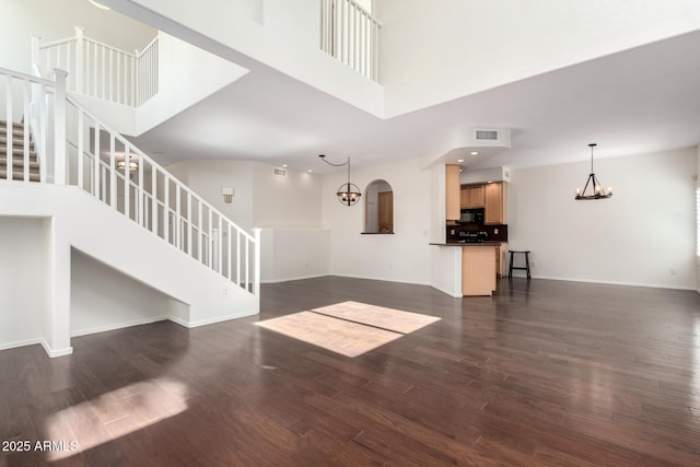 6510 S Hazelton Ln Unit 101, Tempe, AZ 85283 - unfurnished living room featuring a chandelier, stairway, dark wood-type flooring, a high ceiling, and recessed lighting