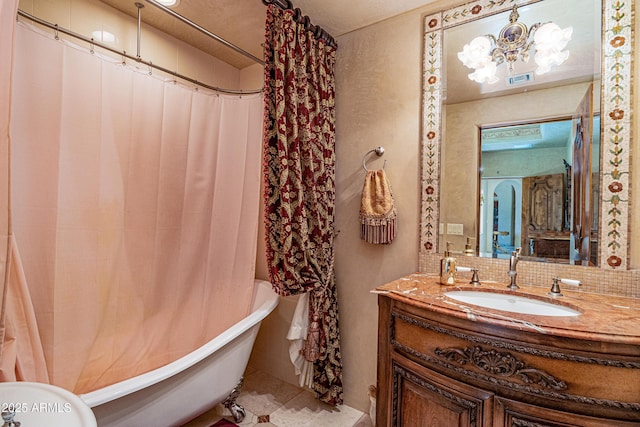 bathroom with vanity, backsplash, shower / tub combo, and a chandelier