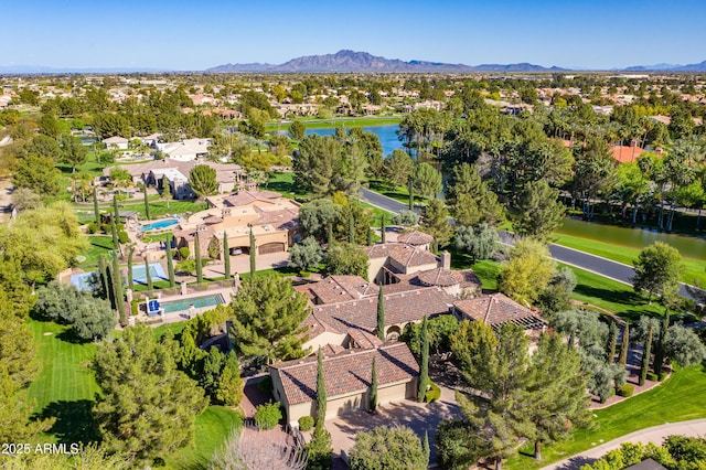 birds eye view of property with a water and mountain view