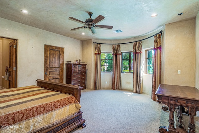 bedroom with carpet, a textured ceiling, and ceiling fan