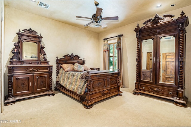 bedroom with ceiling fan and light carpet