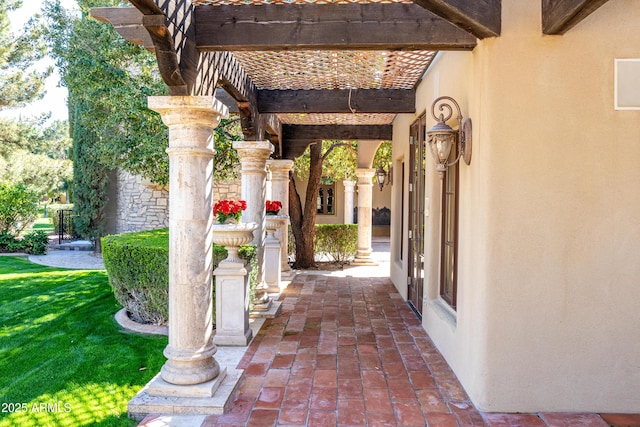 view of exterior entry with a yard