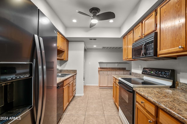 kitchen with stone counters, ceiling fan, sink, light tile patterned flooring, and black appliances