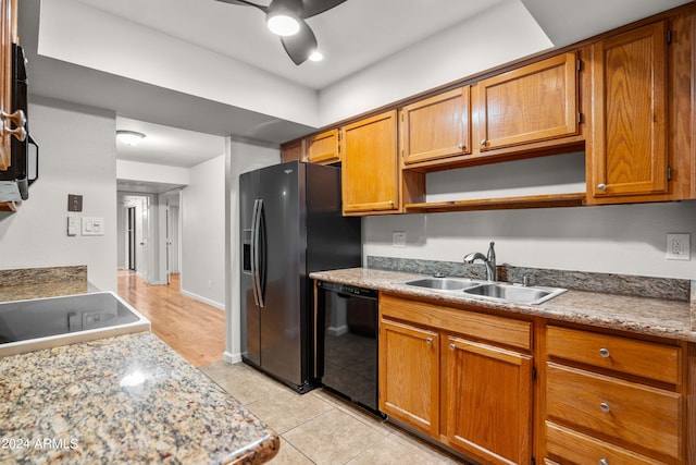 kitchen with sink, ceiling fan, stainless steel fridge, light tile patterned floors, and black dishwasher