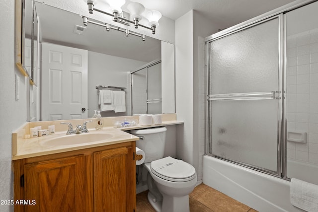 full bath with tile patterned flooring, toilet, combined bath / shower with glass door, and vanity