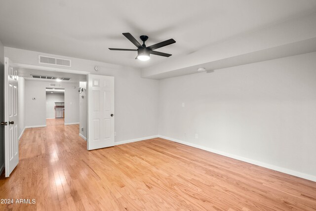 spare room featuring ceiling fan and light hardwood / wood-style floors