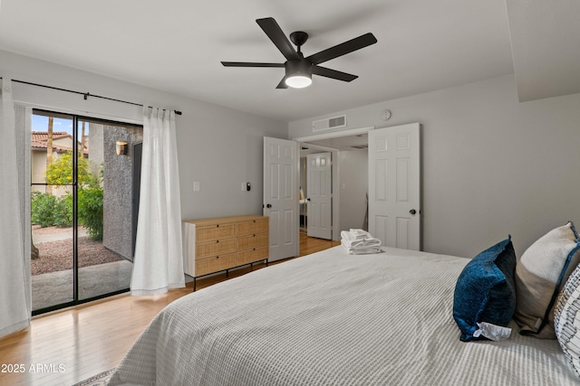 bedroom featuring access to exterior, light wood-style floors, and ceiling fan