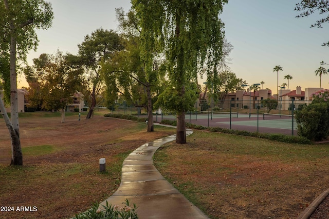 view of property's community featuring tennis court