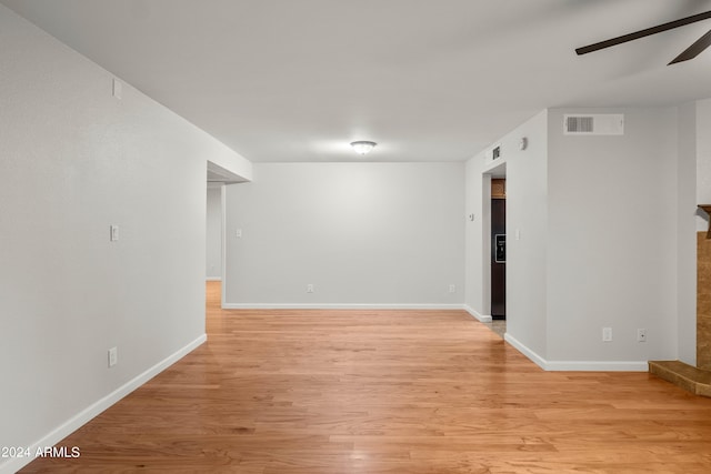 empty room with ceiling fan and light wood-type flooring