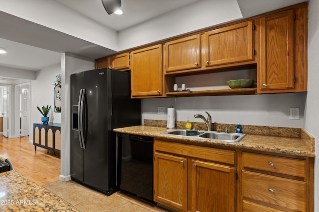 kitchen featuring a sink, black appliances, open shelves, and brown cabinetry