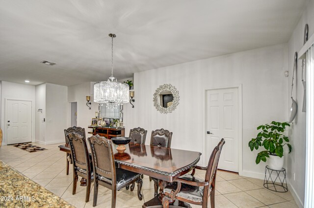 tiled dining space with an inviting chandelier