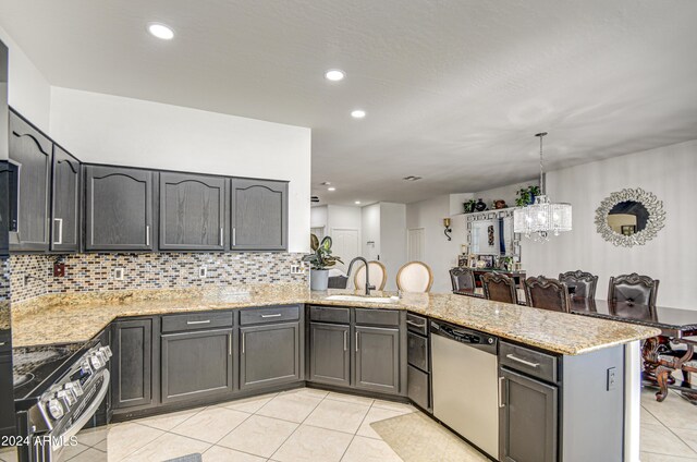 kitchen featuring stainless steel appliances, sink, kitchen peninsula, light tile patterned floors, and light stone countertops