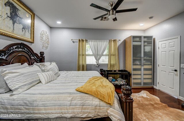 bedroom featuring ceiling fan and hardwood / wood-style flooring