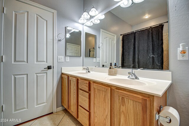 bathroom featuring tile patterned floors and double vanity