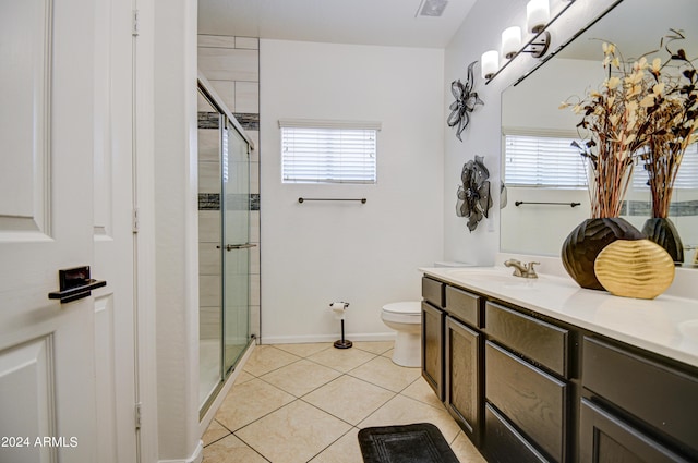 bathroom featuring vanity, toilet, tile patterned flooring, and plenty of natural light