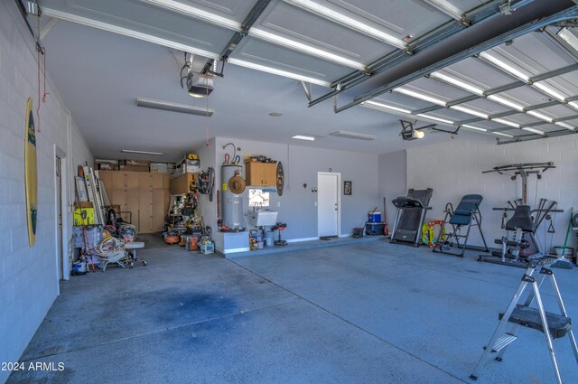 garage with a garage door opener, sink, and water heater