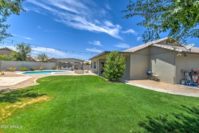 view of yard featuring a patio area and a fenced in pool