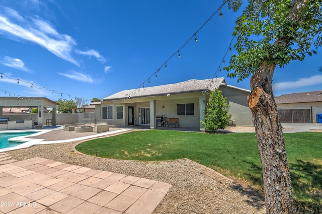 back of house with a patio area, a fenced in pool, and a yard