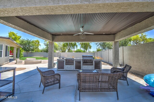 view of patio / terrace with ceiling fan, an outdoor living space, an outdoor kitchen, and a grill