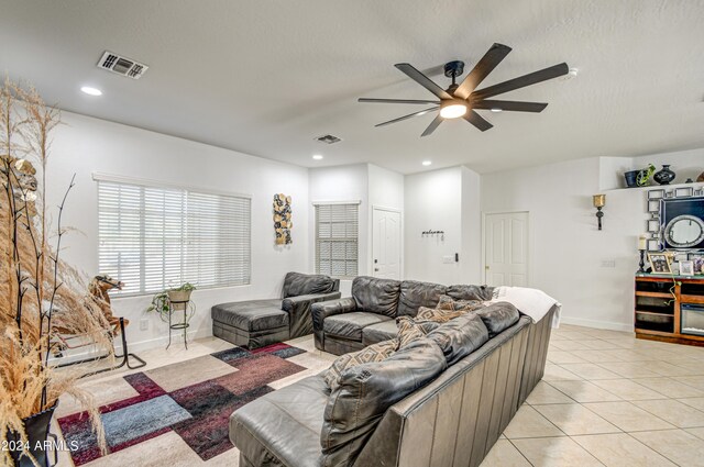 living room with light tile patterned flooring and ceiling fan