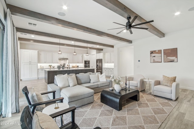 living room with beam ceiling, recessed lighting, visible vents, and light wood-style floors