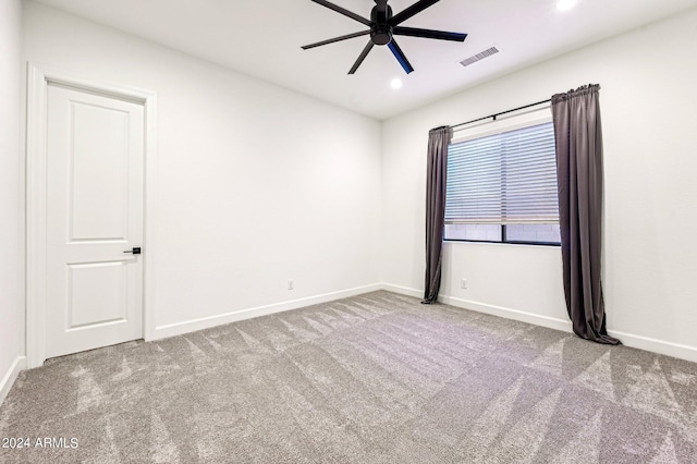 carpeted spare room with a ceiling fan, recessed lighting, visible vents, and baseboards