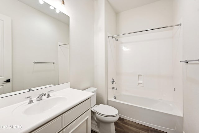 full bathroom featuring toilet,  shower combination, wood finished floors, and vanity