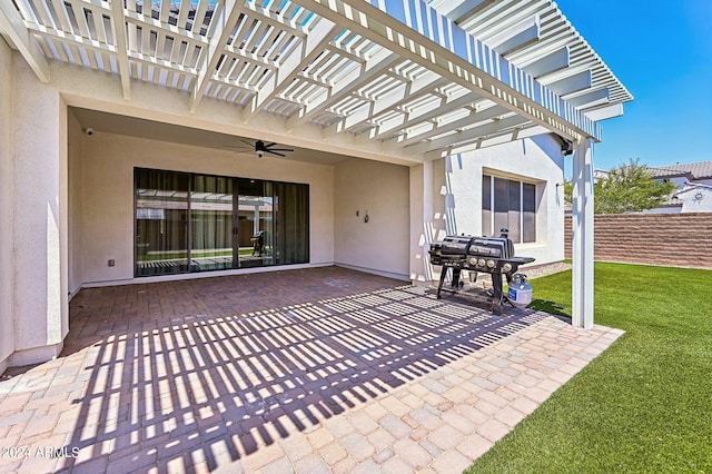 view of patio with ceiling fan, fence, and a pergola