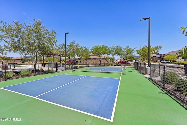 view of tennis court featuring fence