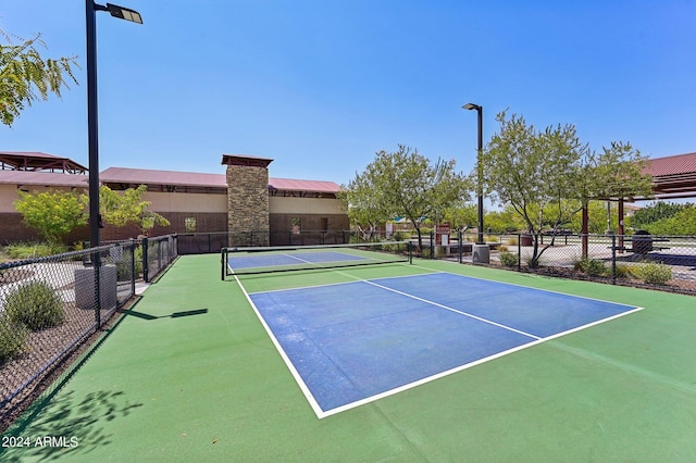 view of sport court featuring fence