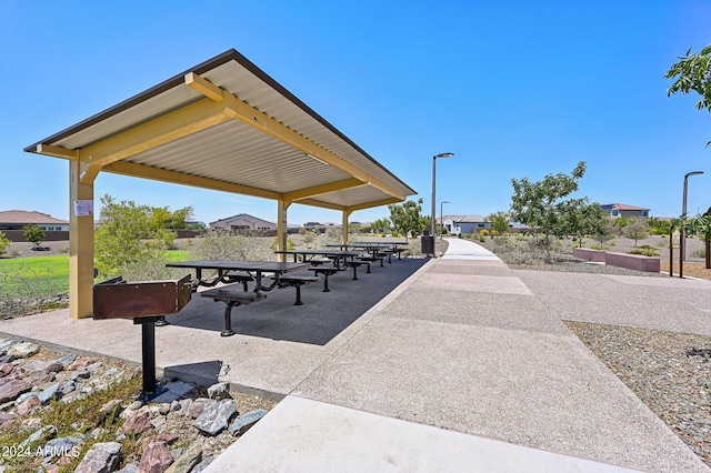 view of home's community with outdoor dining space and a patio area