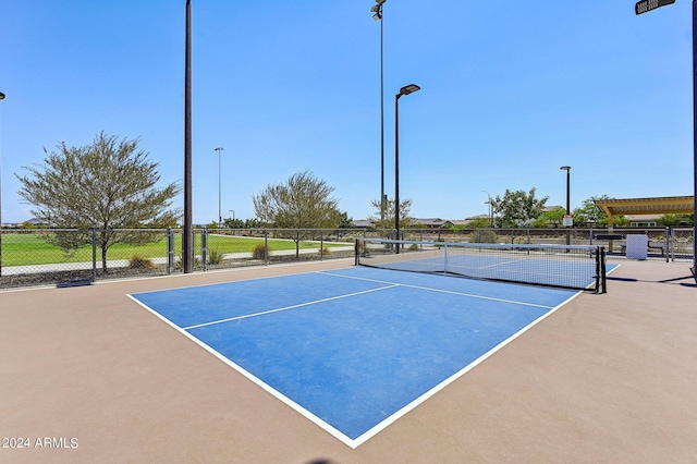 view of sport court featuring fence