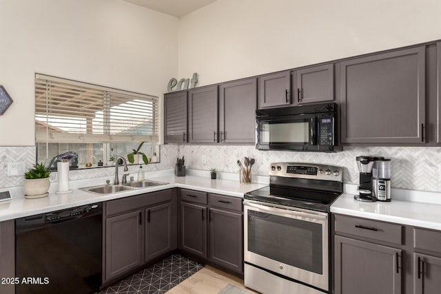 8673 W Palm Ln, Phoenix, AZ 85037 - kitchen with black appliances, backsplash, light countertops, and gray cabinets