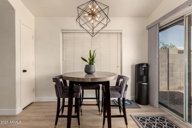 8673 W Palm Ln, Phoenix, AZ 85037 - dining area with a chandelier and light wood-type flooring